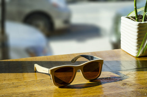 Wood sunglasses wayfarer style on a wooden counter