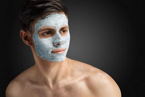 Young man with face mask for acne - natural remedies