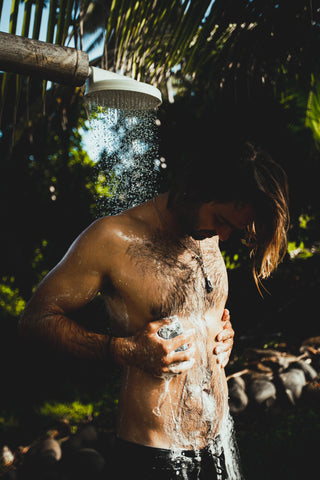 Guy showering outside with natural soap - Soap.Club