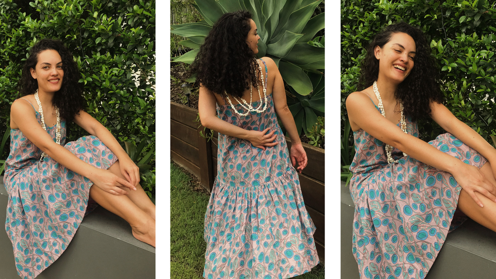 The beautoful Tonganese Mailianive, poses in three different positions, in her garden, wearing the Boom Shankar Sitar Dress in the Rose Quartz design