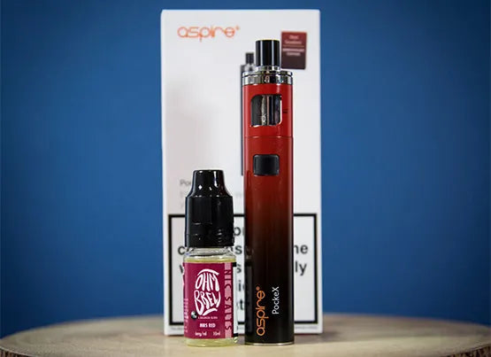 A PockeX AIO vape device stood in front of it's box, with an Ohm Brew 50/50 10ml bottle next to it.