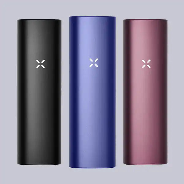 Three PAX Plus Dry Herb Vaporizers on a grey background.