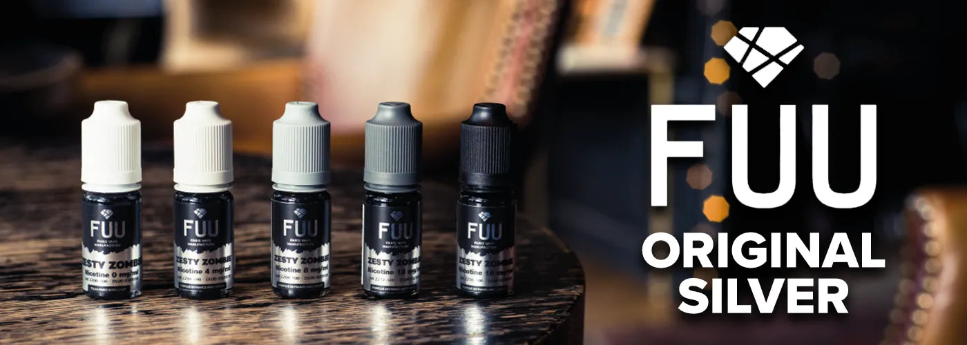 Five 10ml bottles of The Fuu Original Silver on a dark wooden table, with the Fuu Original Silver logo to the right hand side.