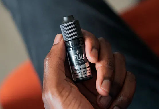 A hand grasping a 10ml bottle of The Fuu Original Silver Lone Cowboy with the camera facing down.