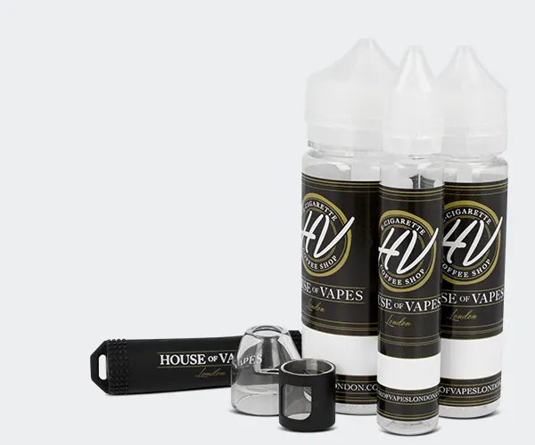 Three shortfill e-liquid bottles, a replacement glass piece and a battery sleeve on a grey background.
