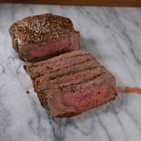 Perfectly Cooked Medium Rare Steak on Cinder Grill