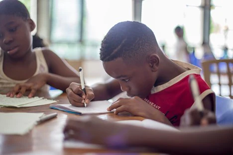 child working on an assignment in the classroom