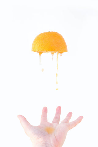 orange being juiced- O2 Living blog makers of organic cold-pressed fruit and vegetable Living Juice