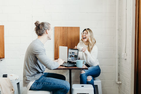 friends talking to improve mood, laughing and smiling 