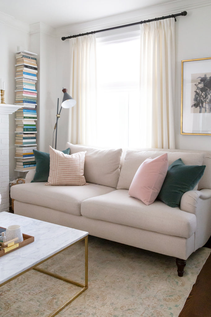 Adena Leigh's neutral living room with Tonic Living pillows, roll-arm sofa, ivory drapes and book nook