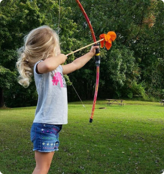 Girl with a kids bow and arrow