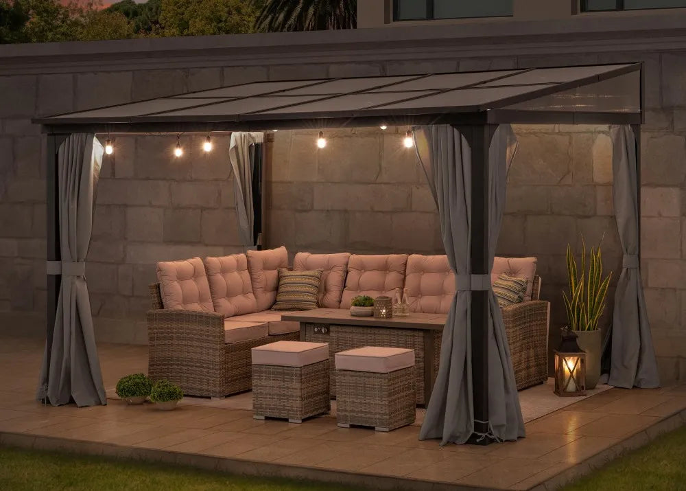 Outdoor patio setup with a sectional sofa, LED string lights, and curtains on a wooden deck.