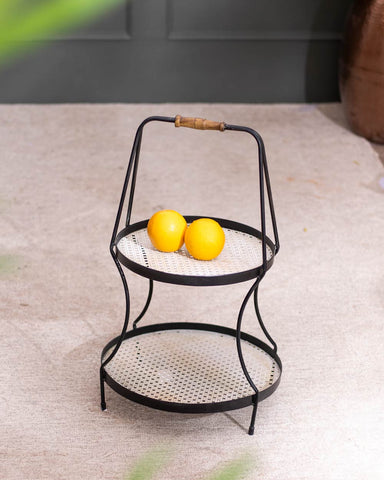 Provence 2-Tier Metal Basket Storage Rack with a rustic black copper finish, displaying vibrant yellow lemons, blending functionality with farmhouse style.