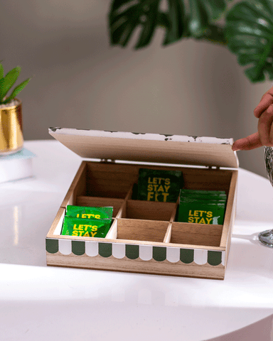 sturdy wooden box opened with compartments having tea bags