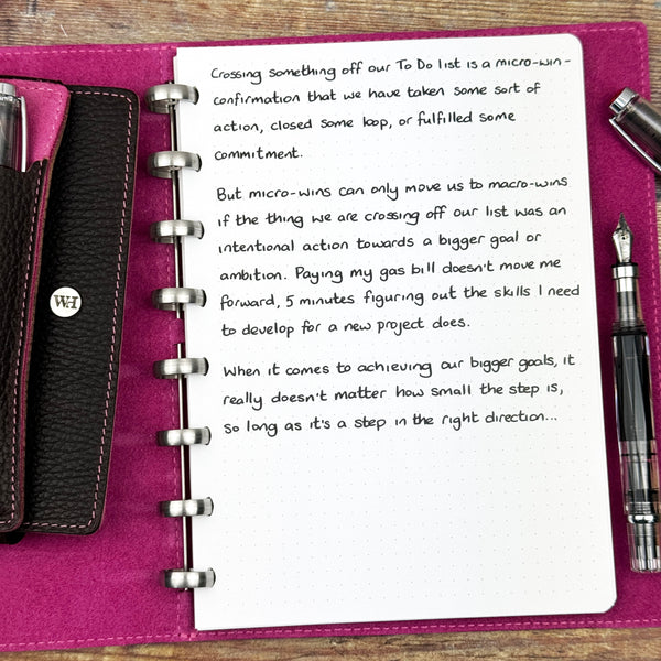 A handwritten page inside an open notebook