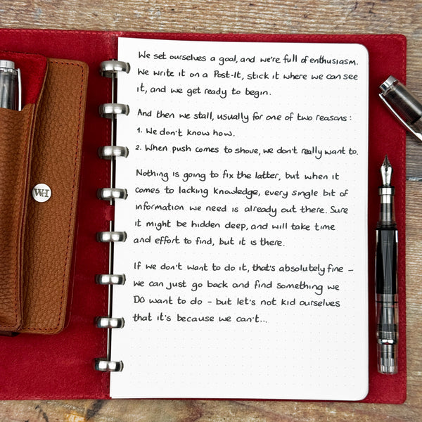 A handwritten page inside an open notebook