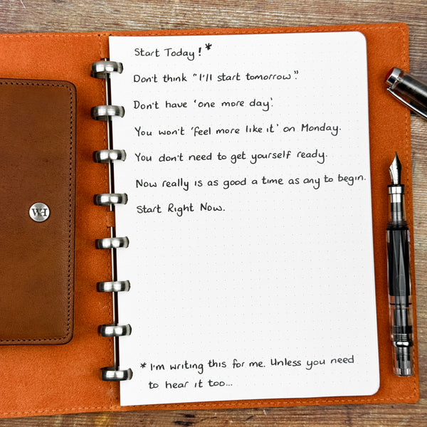 A handwritten page inside an open notebook