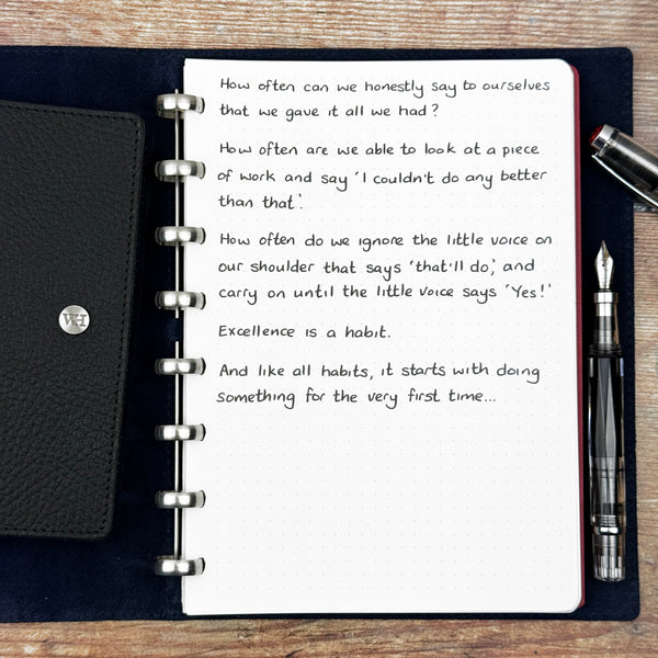 A handwritten page inside an open notebook