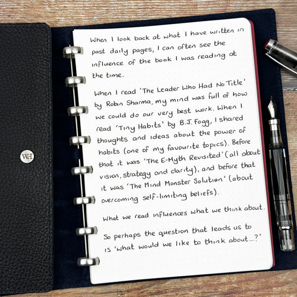 A handwritten page inside an open notebook