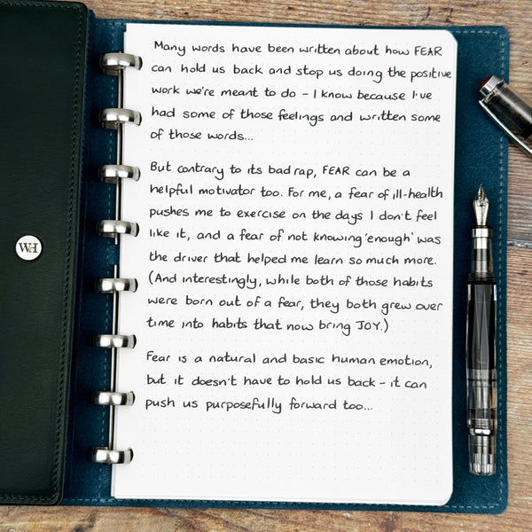 A handwritten page inside an open notebook