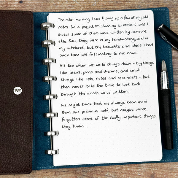 A handwritten page inside an open notebook