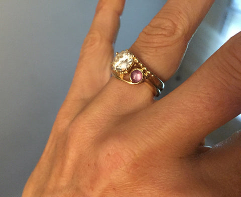Two Stone European Cut Diamond and Star Ruby Yellow Gold Engagement Ring on Joanna Rubini's hand, ring by Rubini Jewelers