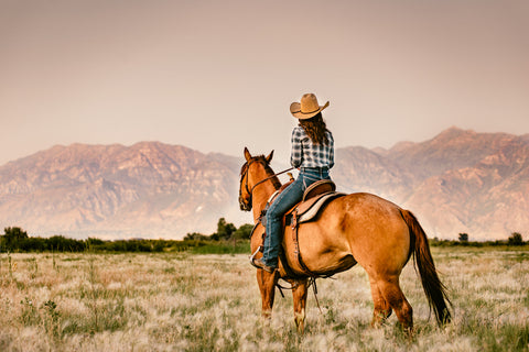 Women on horseback in scenic texas ranch riding western ranch saddle