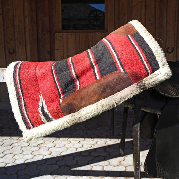 Red Western Saddle Pad Placed On Fence