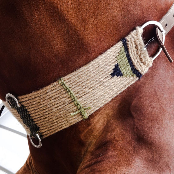 brown horse wearing western saddle cinch