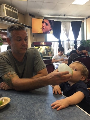 Dad giving baby a bottle