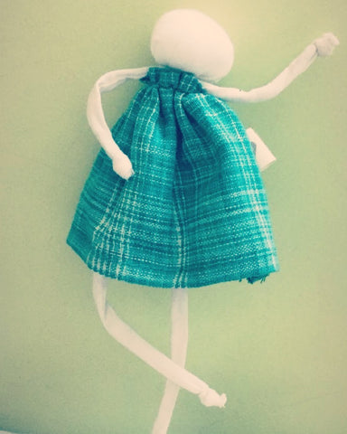A bendable limbs doll made with upcycled handwoven cotton fabric in green colour