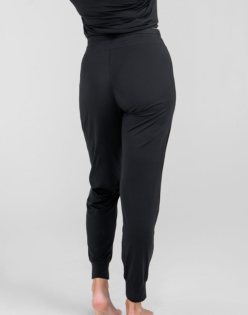 Model Raine wearing BlissWear Jogger in size Medium and color Midnight, seen from the Back
