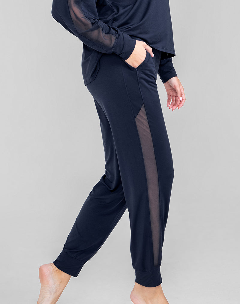 Model Raine wearing BlissWear Jogger in size Medium and color Navy, seen from the Side