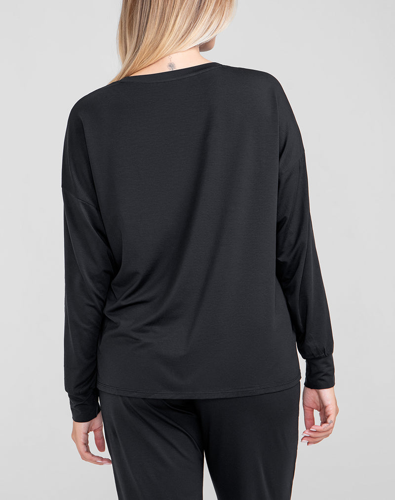 Model Raine wearing BlissWear Long Sleeve Top in size Medium and color Midnight, seen from the Back