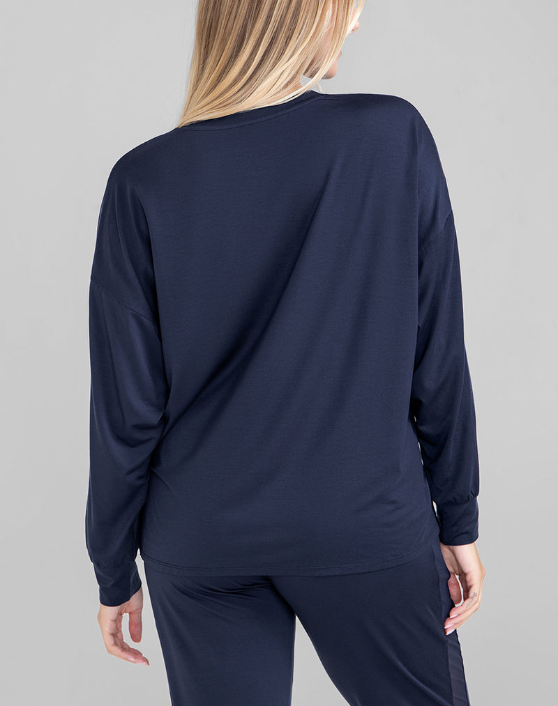 Model Raine wearing BlissWear Long Sleeve Top in size Medium and color Navy, seen from the Back