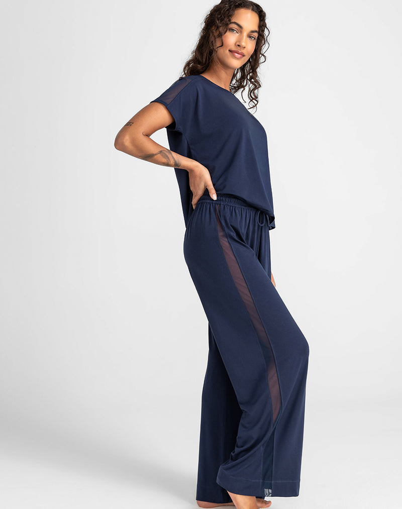 Model Jessica wearing BlissWear Pant in size Small and color Navy, seen from the Side
