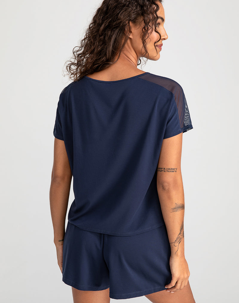 Model Jessica wearing BlissWear Short Sleeve Top in size Small and color Navy, seen from the Back