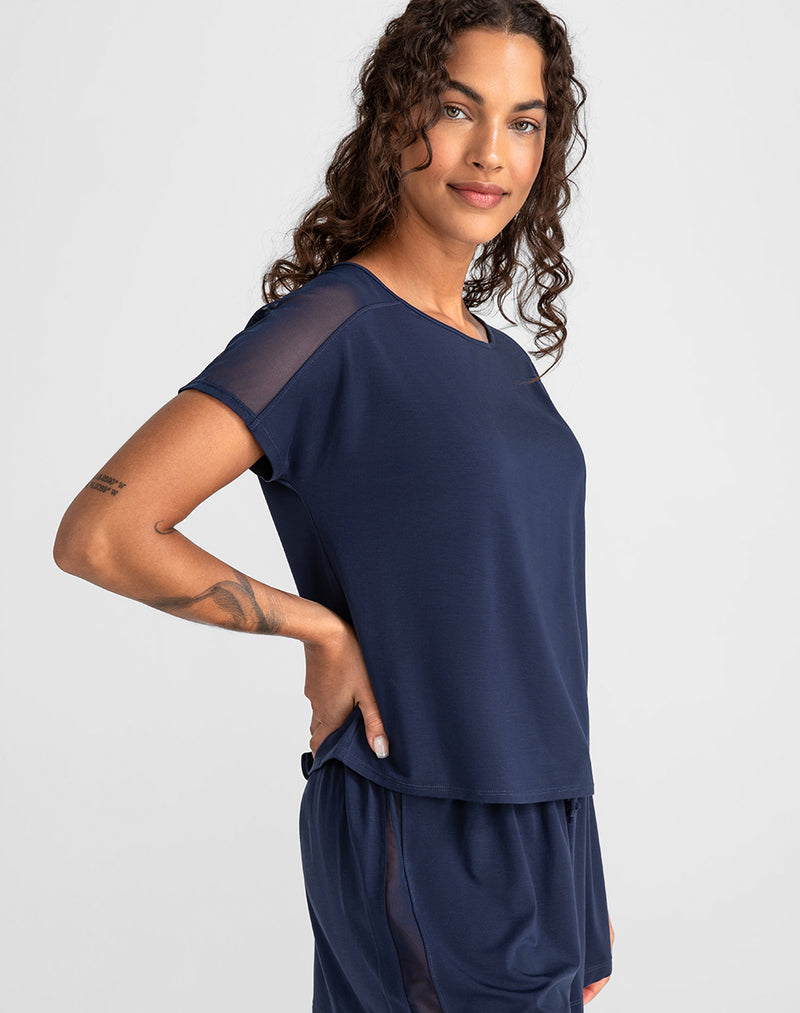 Model Jessica wearing BlissWear Short Sleeve Top in size Small and color Navy, seen from the Side