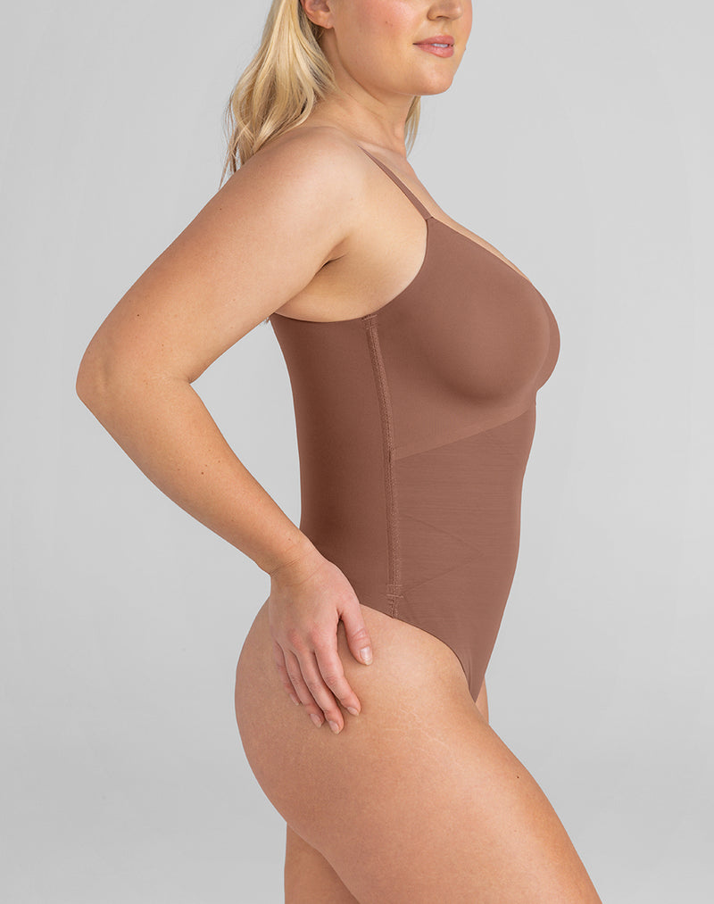 Model McCallah wearing Cami Thong Bodysuit in size Large and color Toffee, seen from the Side