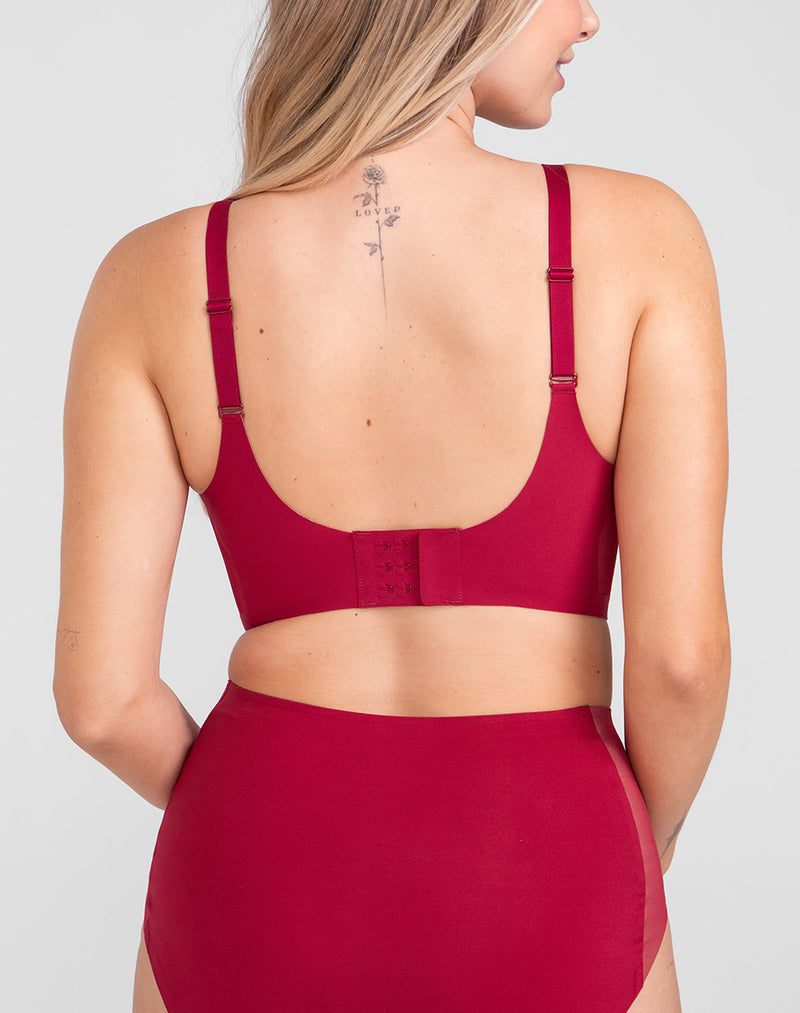 Model Raine wearing CrossOver Bra in size Medium and color Ruby, seen from the Back