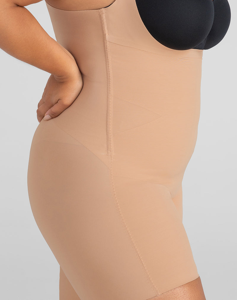 Detail of model wearing Open-Bust Mid-Thigh Bodysuit in color Sand