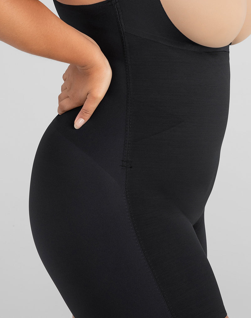 Detail of model wearing Open-Bust Mid-Thigh Bodysuit in color Vamp