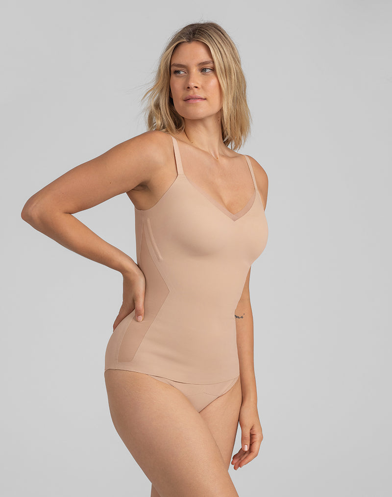 Model Elle wearing CrossOver Cami in size Small and color Sand, seen from the Side