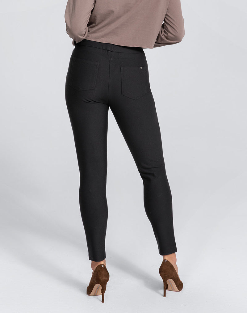 Model Elle wearing EverReady Pant in size Medium and color Jet Black, seen from the Back