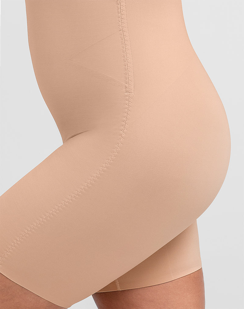Detail of model wearing Mid-Thigh Bodysuit in color Sand