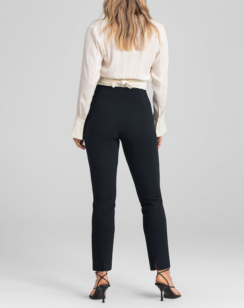 Model Elle wearing Perfectionist Pant in size Medium and color Jet Black, seen from the Back