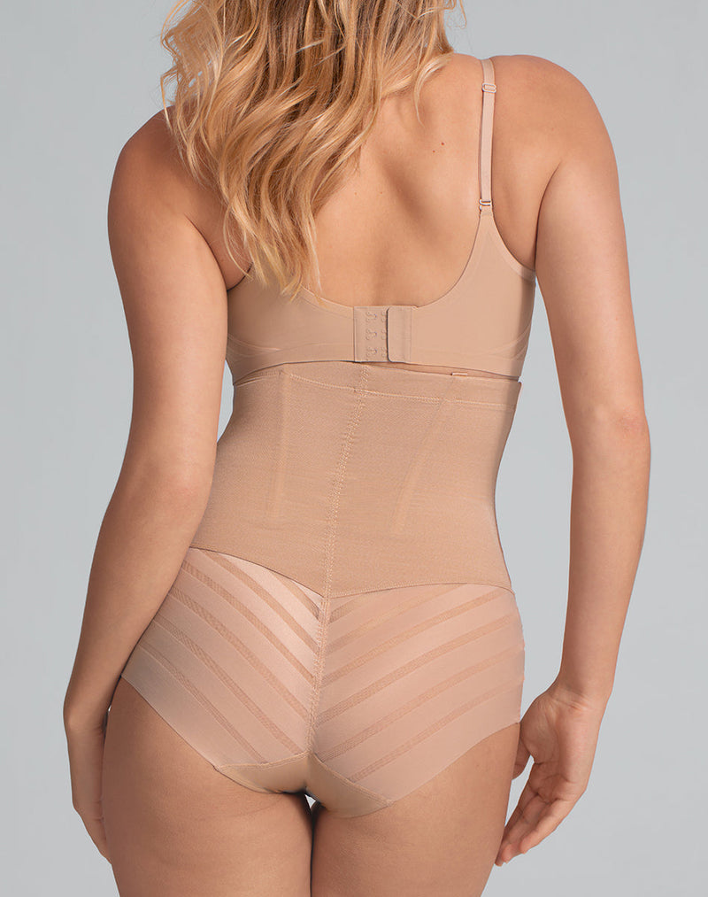 Model Elle wearing Queen Brief in size Medium and color Sand, seen from the Back