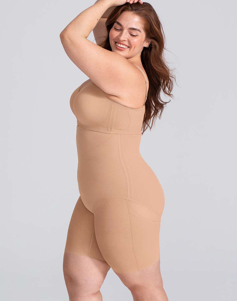 Model Brianna wearing SuperPower Short in size Plus size one and color Sand, seen from the Side