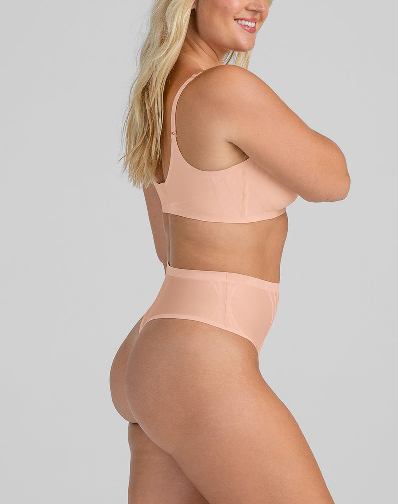 Model McCallah wearing Silhouette Thong in size Large and color Rose Tan, seen from the Side