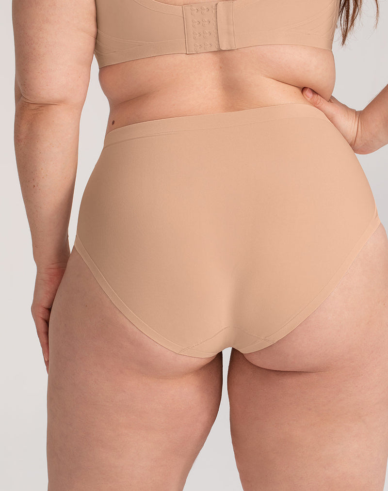 Model Brianna wearing Silhouette Brief in size Plus size one and color Sand, seen from the Back